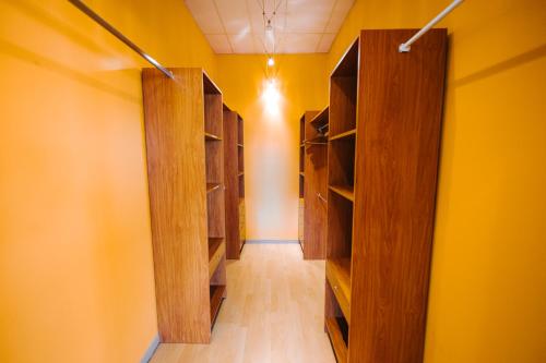 a hallway with wooden shelves and a yellow wall at Le LOFT de la Route des Vins in Guebwiller