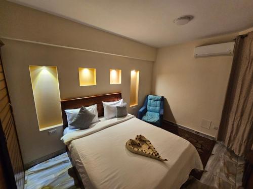 a hotel room with a bed with a plate of food on it at Midpoint Sea View - families only in Alexandria