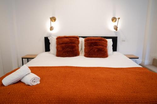 a bedroom with a bed with towels on it at The Amazing Triplex - City Centre - Free Parking in Sheffield