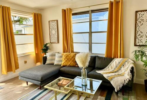 a living room with a couch and a table at Lush tropical big home close to Airport, Calle 8, Coral Gables and lots more Miami amenities in Miami
