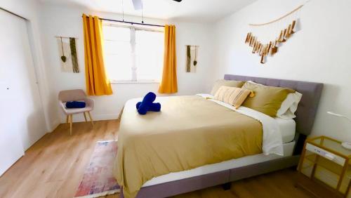 a bedroom with a large bed with a blue toy on it at Intimate Casita Mia minutes away from Airport, Calle 8, Brickell, Coral Gables, The beach and more! in Miami