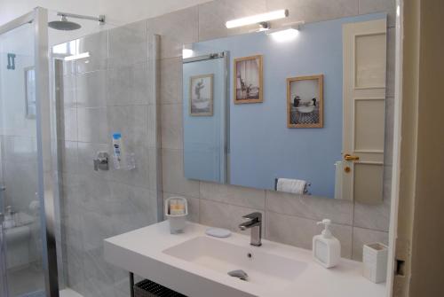 a bathroom with a sink and a mirror at Alloggio turistico in Pisa