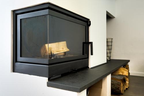 a fireplace in a living room with a black mantle at House Big Win Mělník in Mlazice