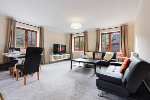 a living room with a couch and a table at Cozy 2bed flat with free parking near Willen Lake in Milton Keynes in Milton Keynes