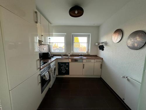 a small kitchen with a sink and a stove at Rose in Rosenfeld