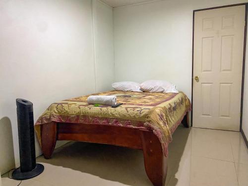 a small bed in a room with two pillows on it at Hospedaje Shaddai in Palo