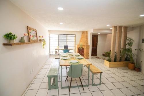 a dining room with a table and chairs in a room at Villa Azul Pool House - Centro Oaxaca in Oaxaca City