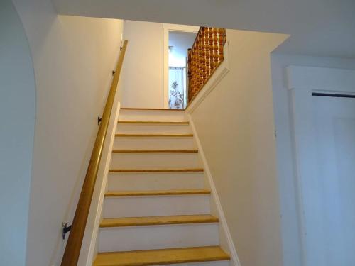 a staircase leading up to the basement of a house at Spacious 4 bedroom home with large yard in Wayland
