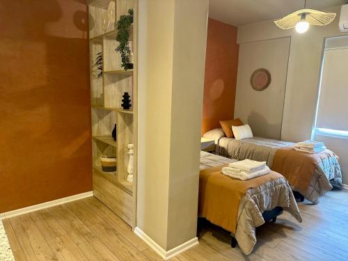 a room with two beds and a closet with two beds at Bari 413 Dpto 2 B in La Rioja