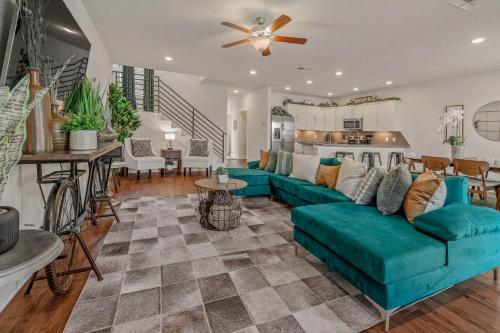 a living room with a blue couch and a kitchen at The Green House in College Station