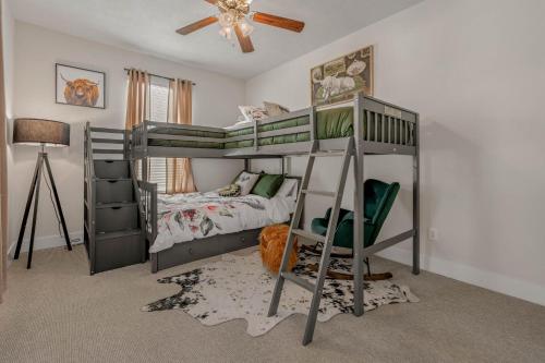 a bedroom with two bunk beds and a ceiling fan at The Green House in College Station