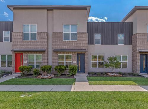 an apartment building with a red door at The Green House in College Station