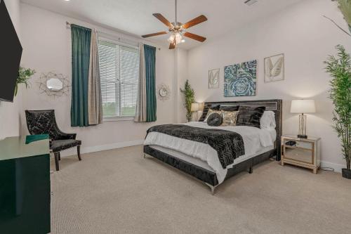 a bedroom with a bed and a ceiling fan at The Green House in College Station