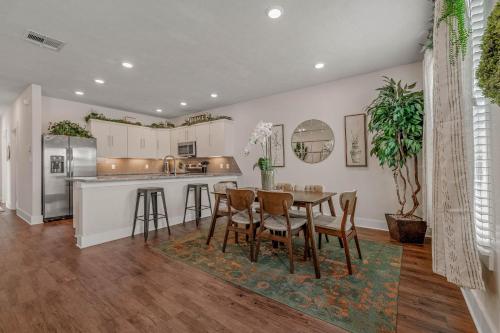 a kitchen and dining room with a table and chairs at The Green House in College Station