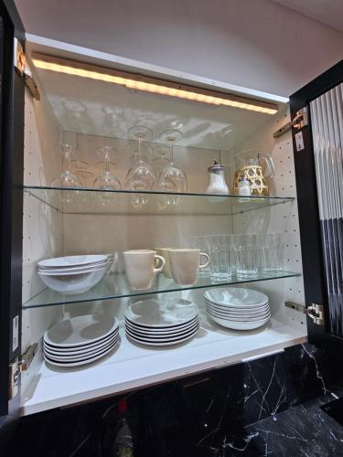 a cabinet filled with plates and cups and dishes at Bear Homes - Olimpia Suite in Valencia