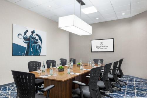 a conference room with a long table and chairs at Sheraton Suites Chicago O'Hare in Rosemont