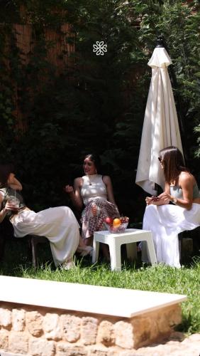 a group of people sitting in the grass at Batroun Old Town private duplex with garden in Batroûn