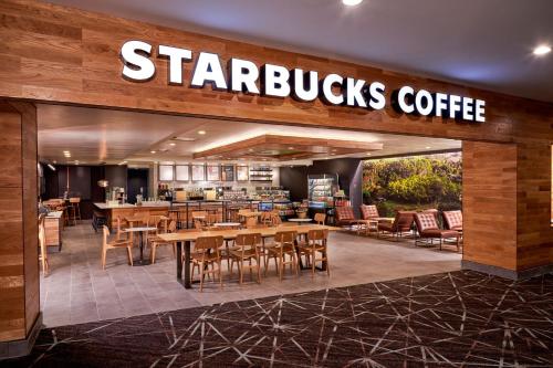 a starbucks coffee restaurant with tables and chairs at The Westin Las Vegas Hotel & Spa in Las Vegas