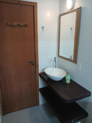 a bathroom with a sink and a mirror on a counter at Casa Super Astral no Sul da Ilha in Florianópolis