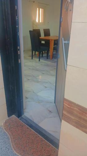 an open door to a dining room with a table at اهلا بيكم في بيتنا in Jazīrat al ‘Awwāmīyah