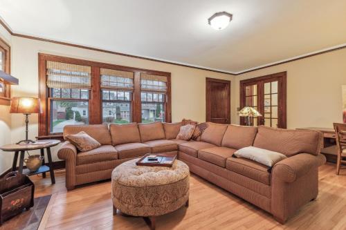 a living room with a couch and a table at Charming Ann Arbor Retreat Near DT & Attractions home in Ann Arbor