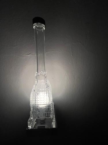 a glass lamp sitting on top of a table at Estilenuevo Fashion Rooms in Druento