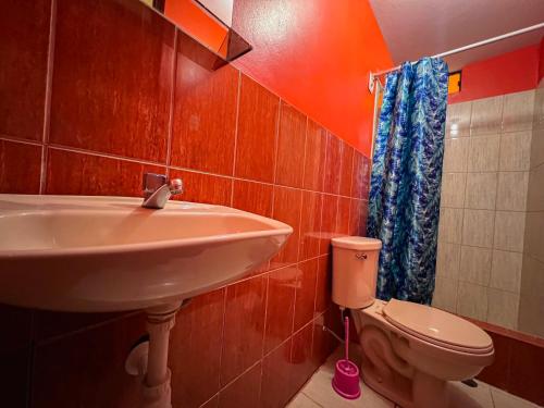 a bathroom with a sink and a toilet at Tony Montaña B&B in Huaraz