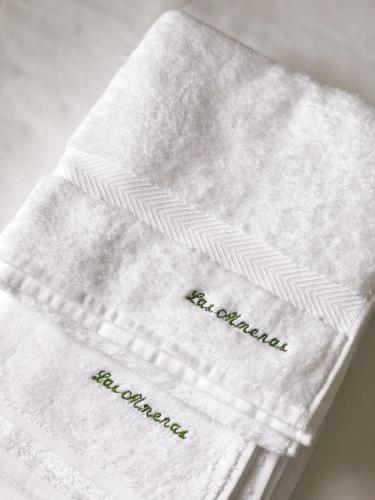 a white towel with embroidery on it on a table at Villas Las Almenas in Maspalomas