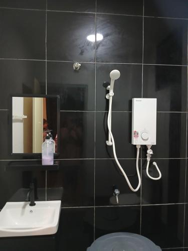 a bathroom with a blow dryer and a sink at Fary Inn Alor Gajah Melaka - Mslim Only in Kampong Alor Gajah