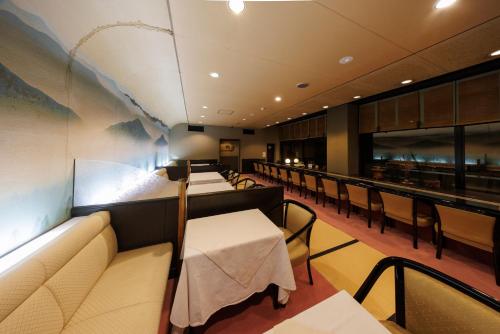 a restaurant with a row of tables and chairs at 四季亭 Shikitei in Nara