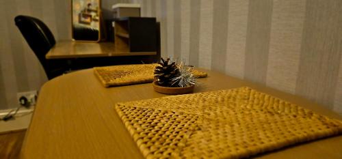 a wooden table with a potted plant on top of it at Home away from home in Aberdeen
