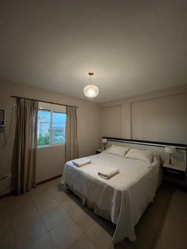 a bedroom with a large bed and a window at Altos Resistencia in Resistencia