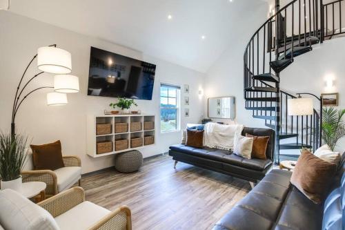 a living room with a couch and a staircase at Luxury Barndo 2B Europe Style Farm Stay Fresh Eggs in Jefferson City