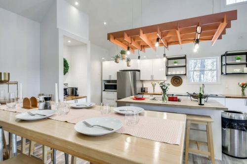 a kitchen with a wooden table with plates on it at Luxury Barndo 2B Europe Style Farm Stay Fresh Eggs in Jefferson City