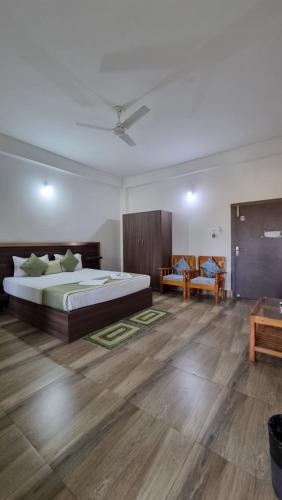 a large bedroom with a bed and a couch at Shivaji Inn Kaziranga in Kāziranga