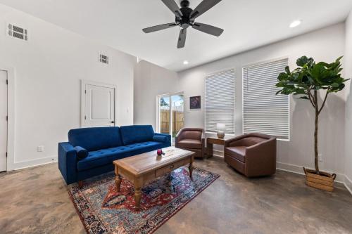 a living room with a blue couch and a table at Basin House 2 King Beds 70in TV Fast WiFi in Lafayette