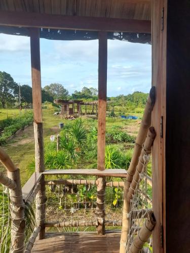 a view from a porch with a view of a field at Tribu Kihud "Experience Simple Living" in Siquijor