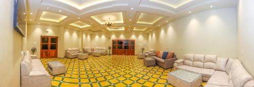 a large room with couches and chairs in it at Nilan Zingle Resort in Puducherry