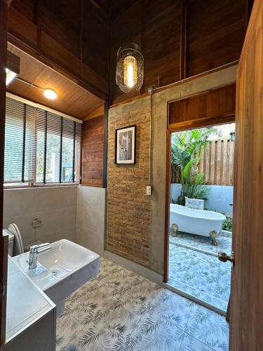 a bathroom with a bath tub and a sink at Aan cafe&stay in Chiang Mai
