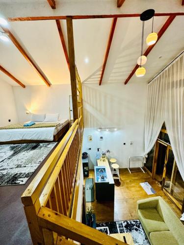 a bedroom with two beds and a desk in a room at Dieng Faeyza Homestay in Dieng