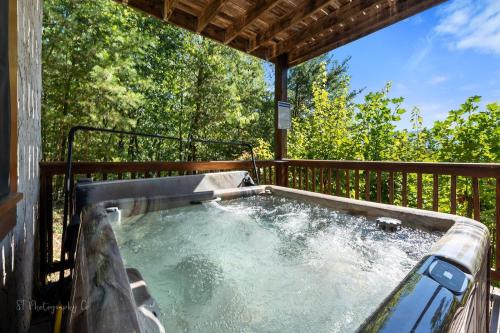 a hot tub on the deck of a house at Eagles Point Cabin in Park Settlement