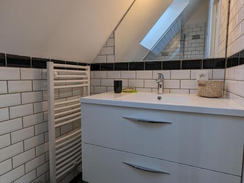 a bathroom with a sink and a mirror at Gîtes modulables entre Loire et Sologne avec jardin et barbecue - FR-1-590-528 in Saint-Firmin-sur-Loire