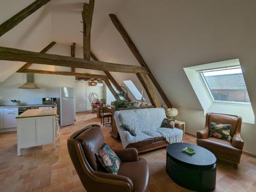 a living room with two chairs and a table at Gîte en forêt avec jardin, terrasse et parking près de la Loire - FR-1-590-530 in Saint-Firmin-sur-Loire