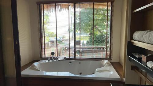 a bath tub in a bathroom with a large window at Better View Koh Yao Yai in Ko Yao Yai