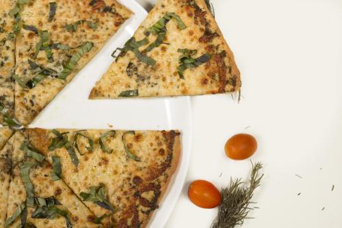 three slices of pizza on a plate with tomatoes at Baldi Hot Springs Hotel & Spa in Fortuna