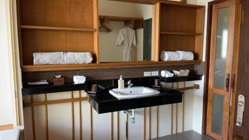 a bathroom with a sink and a mirror at Better View Koh Yao Yai in Ko Yao Yai