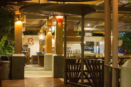 a restaurant with a bar with a large umbrella at Baldi Hot Springs Hotel & Spa in Fortuna