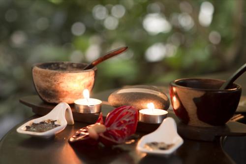 a table with candles and tea cups on it at Baldi Hot Springs Hotel & Spa in Fortuna