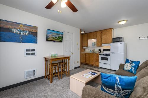 a living room with a couch and a table at Ocean Suites Motel in Brookings