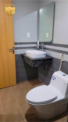 a bathroom with a toilet and a sink at Rosetta Hotel Phu Quoc in Phu Quoc